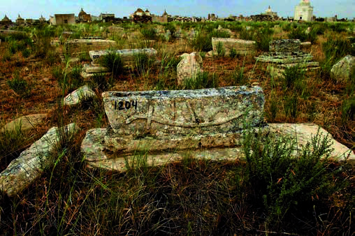 Sisem ata. One of the views of the ancient part of the necropolis. In the foreground: a tombstone with the image of a saber (kylysh).Photo by S.E. Azhigali, 2012